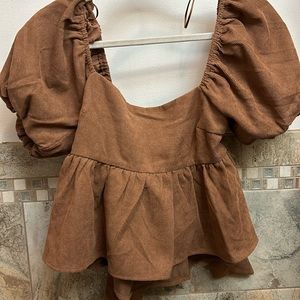 Brown corduroy off the shoulder shirt pairs well with jeans